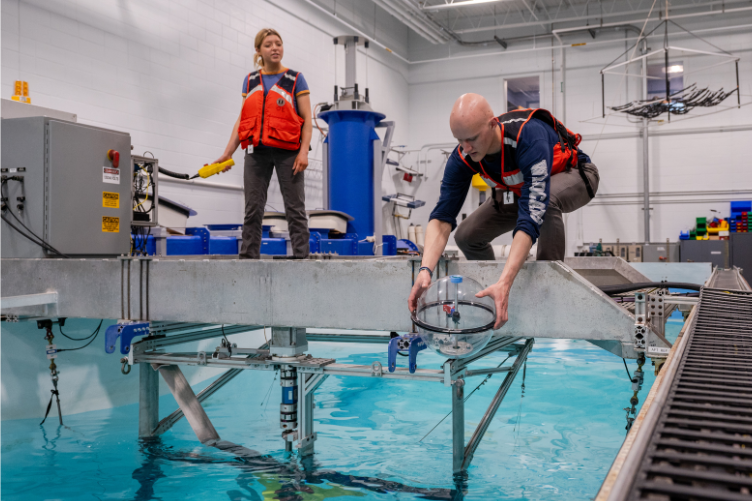 Members of the Drift-RMT prepare to test their buoy at the Chase Ocean Engineering Lab.