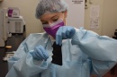 Lab worker swabs a gun grip